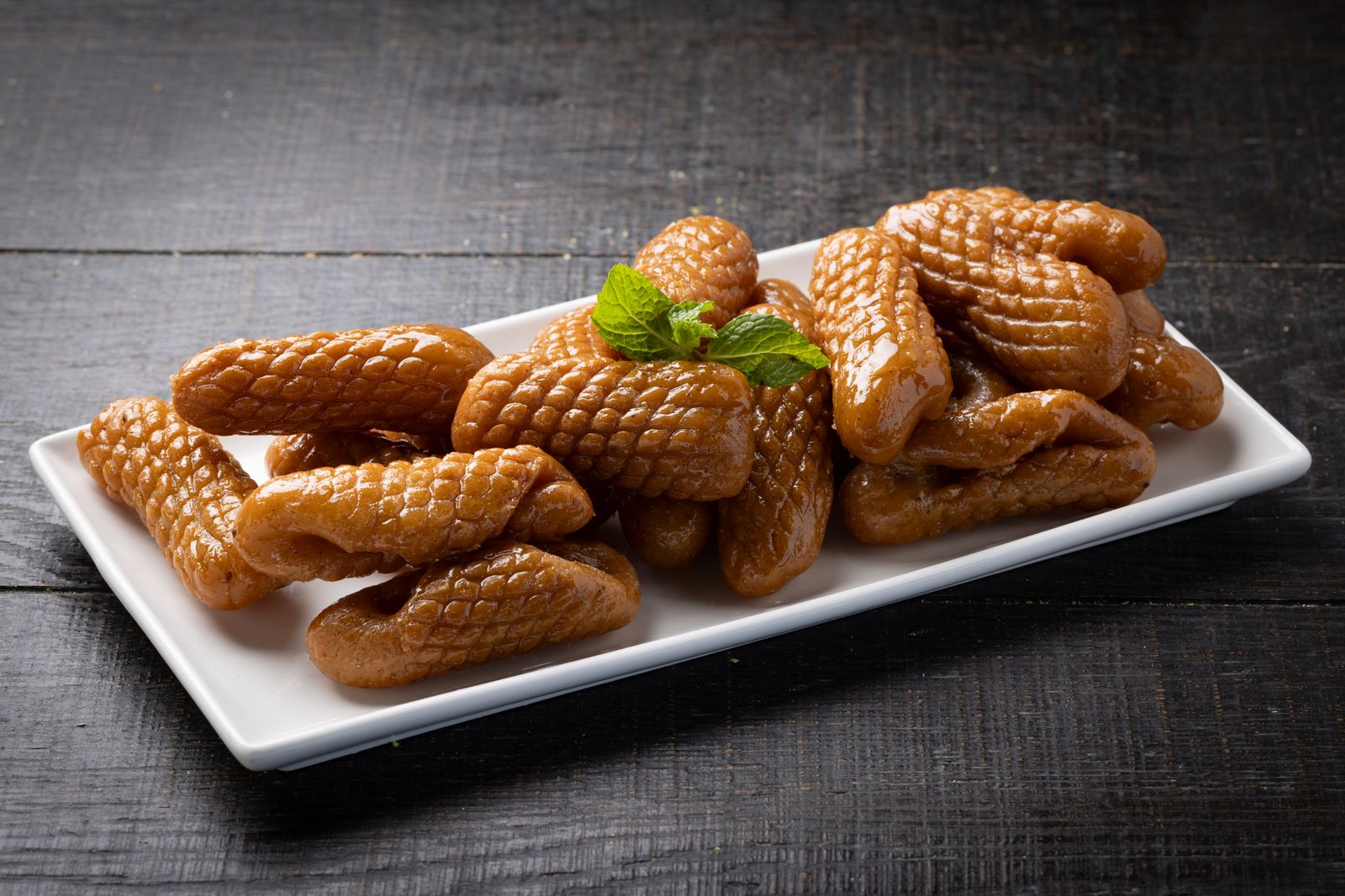 Asabeh Zainab, ridged syrup-glazed pastry fingers, garnished with mint