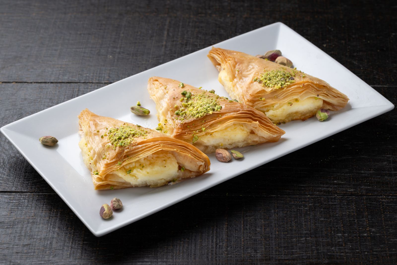 Cream-filled filo triangles sprinkled with pistachio